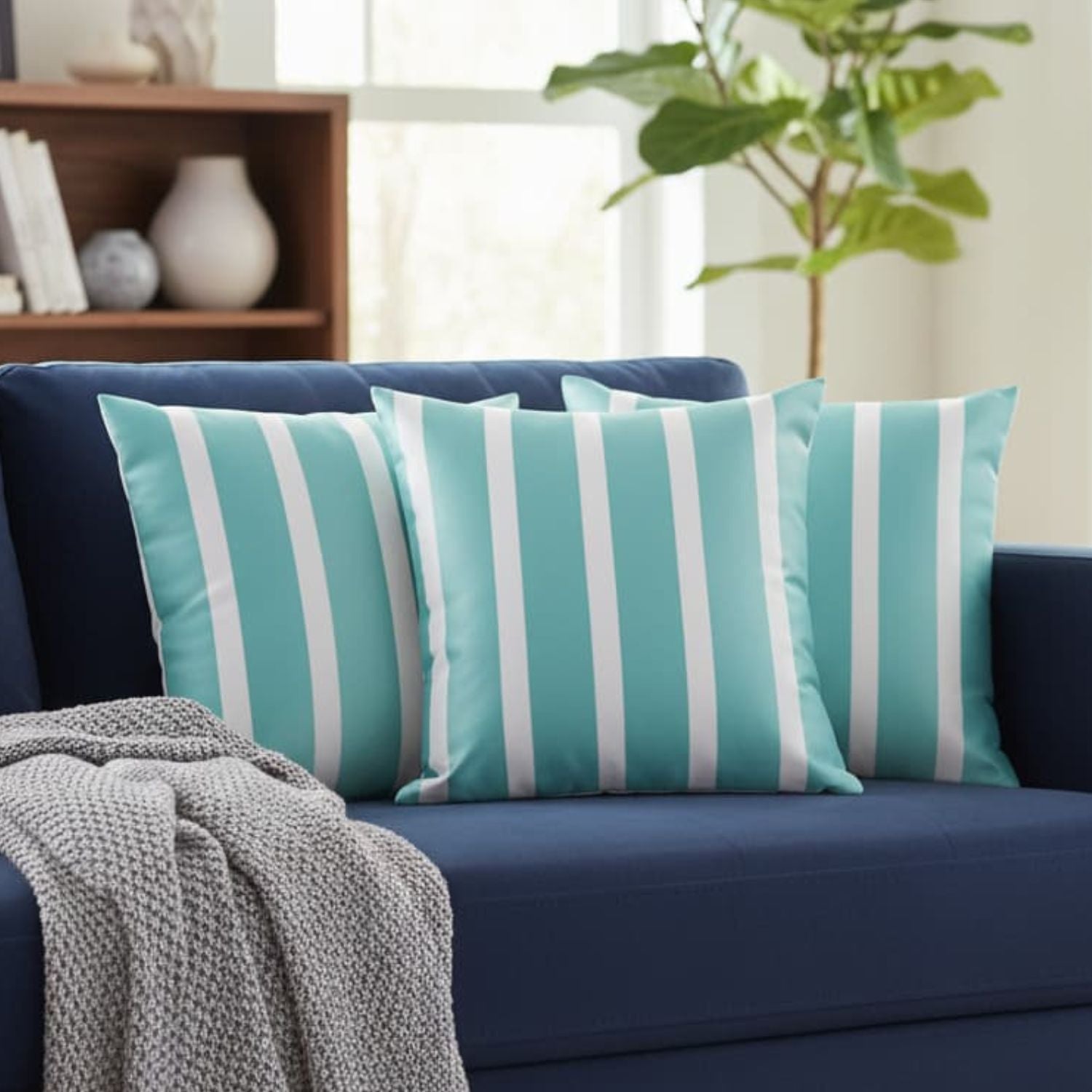 Loosebucket Blue sofa with turquoise and white striped cushions in a living room setting.