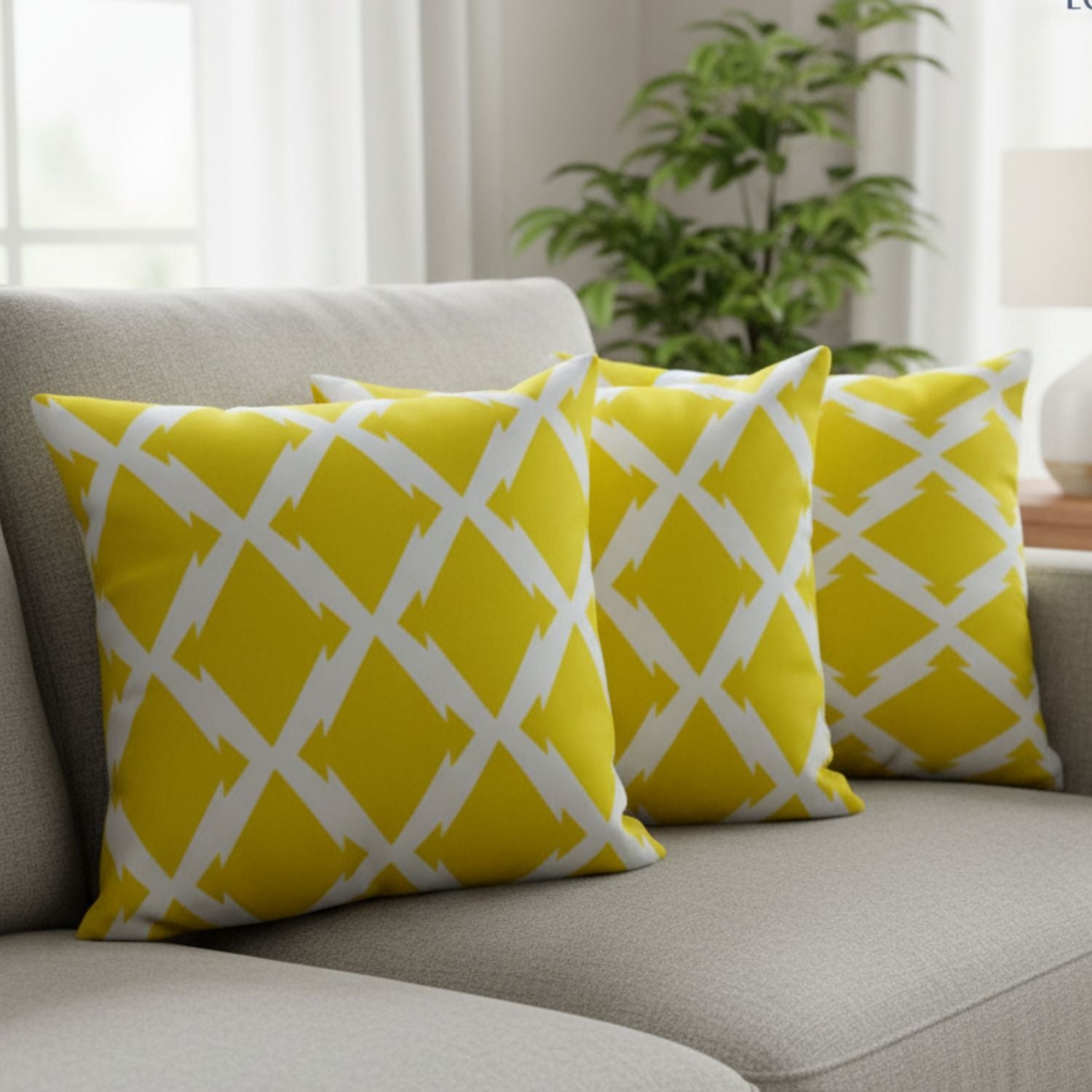 Loosebucket Lemon Shot Cushion Covers Yellow pillows with white patterns on a gray sofa in a living room setting.