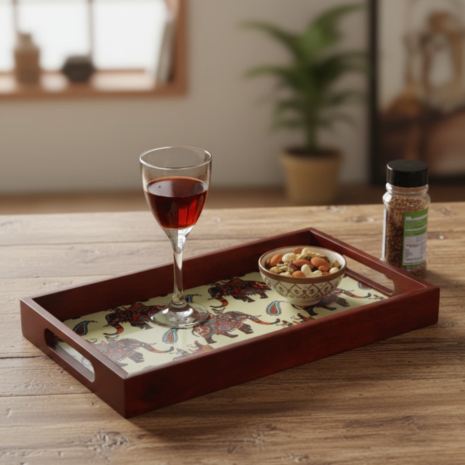 Loosebucket Walking Elephant Wooden tray tray with a glass of red wine and a bowl of nuts on a wooden table.