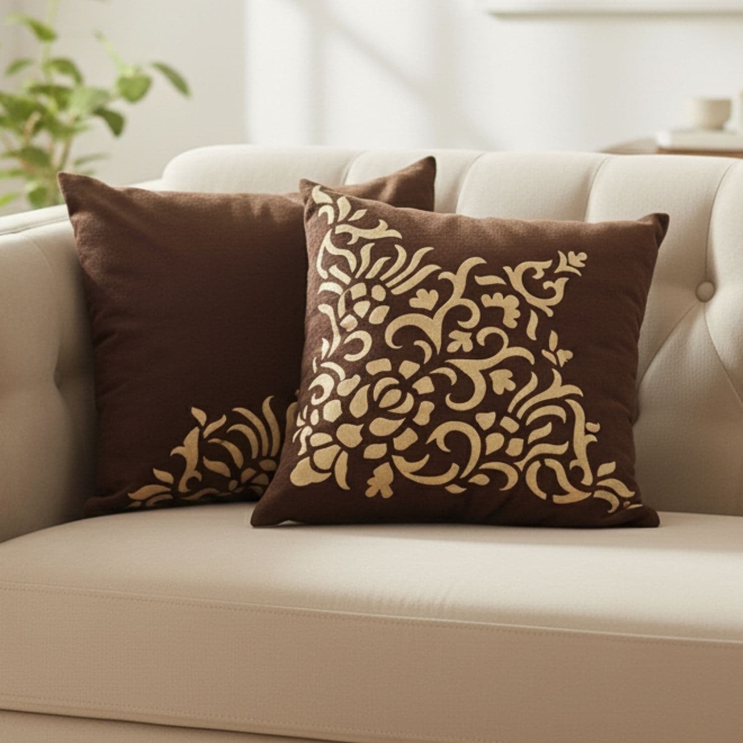 Loosebucket Brown Town Cushion Covers Decorative brown cushions with gold patterns on a beige sofa.