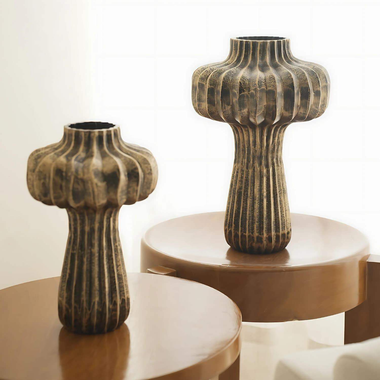 Premium Vintage Portobello Aluminum Vases featuring two mushroom-shaped decorative pieces in antique golden brown finish, displaying ribbed patterns and elevated on circular brown platforms. Set includes 16-inch and 12-inch vases with distinctive bulbous tops and slender stems.