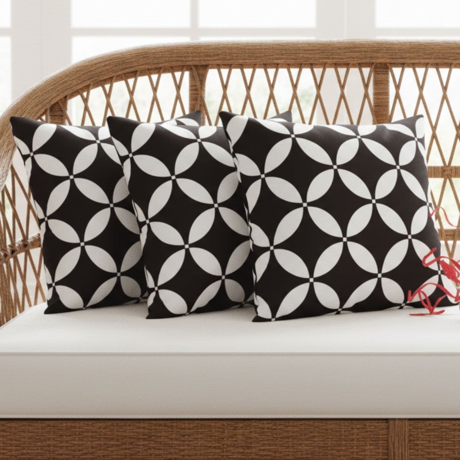 Loosebucket Black Luxury cushion covers ,Black and white patterned pillows on a wicker bench with a neutral background