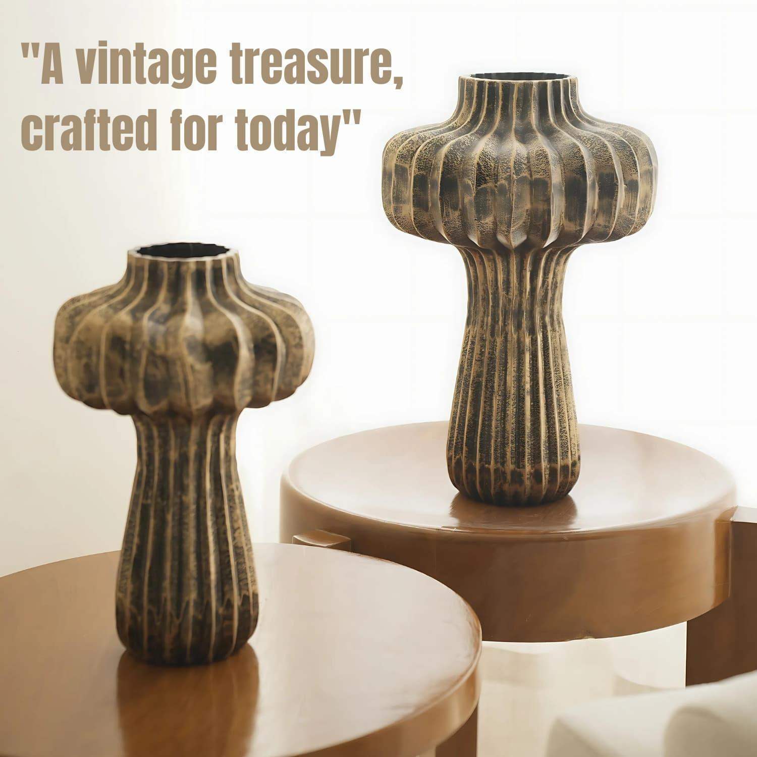 Premium Vintage Portobello Aluminum Vases displayed on brown circular platforms. Set of two mushroom-shaped vases in antique golden brown finish with ribbed texture patterns. Taller vase measures 16 inches, shorter 12 inches, both featuring bulbous tops and slender stems.