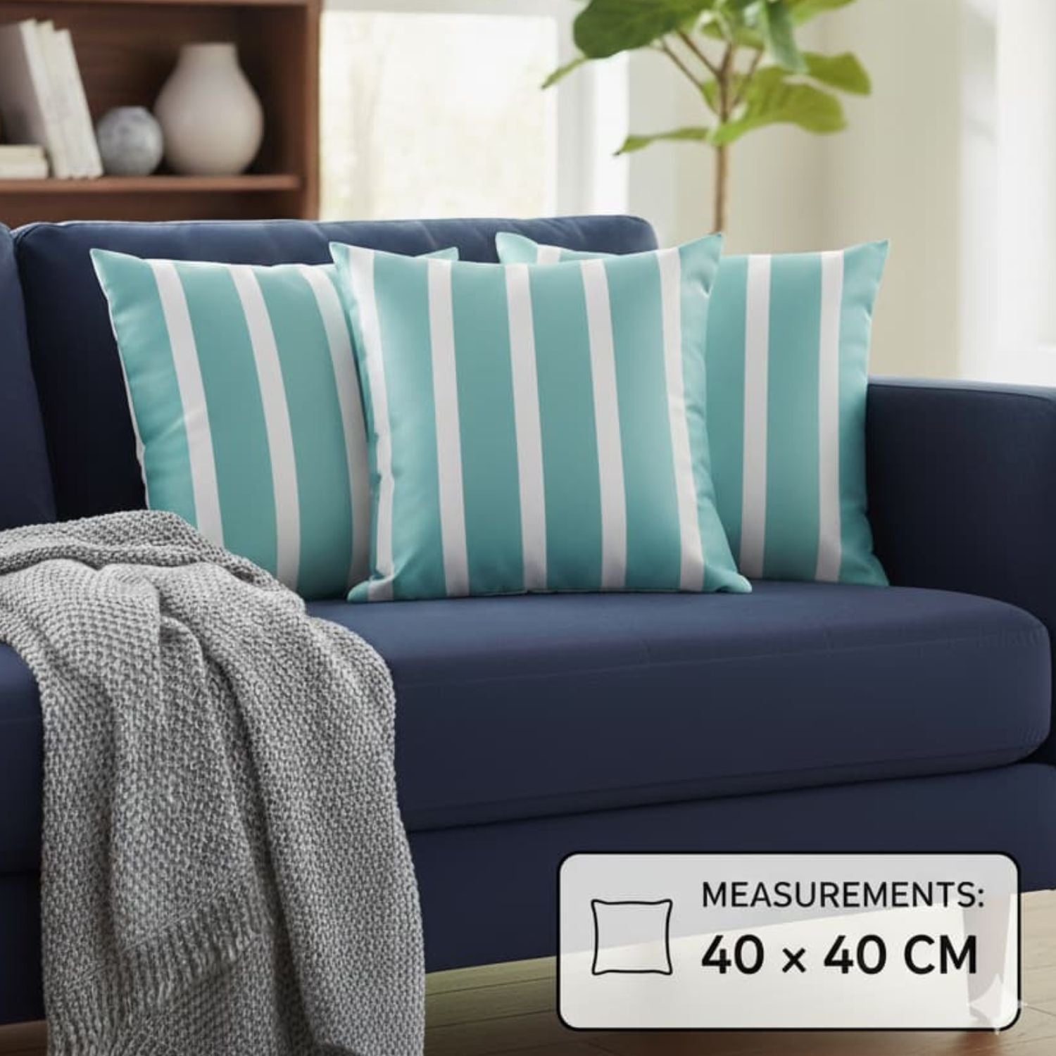 Loosebucket Teal and white striped cushions on a navy blue sofa with a gray blanket, in a living room setting with measurement of cushions 