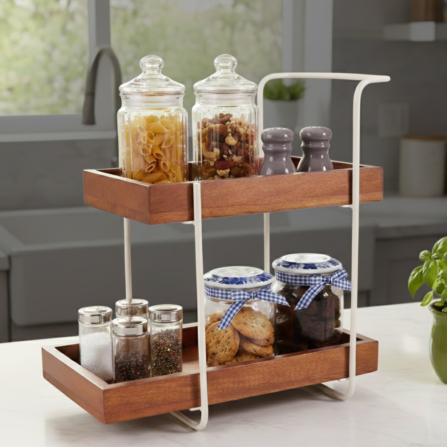 Loosebucket Woodnest  two-tier wooden kitchen organizer with a drawer and metal accents, displaying various kitchen items like jars and containers.
